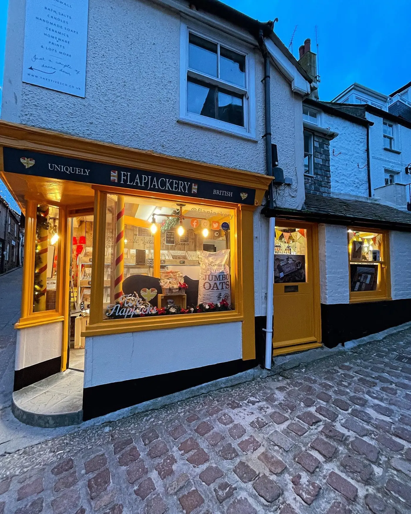 Traditional corner shop front with gold and black paintwork
